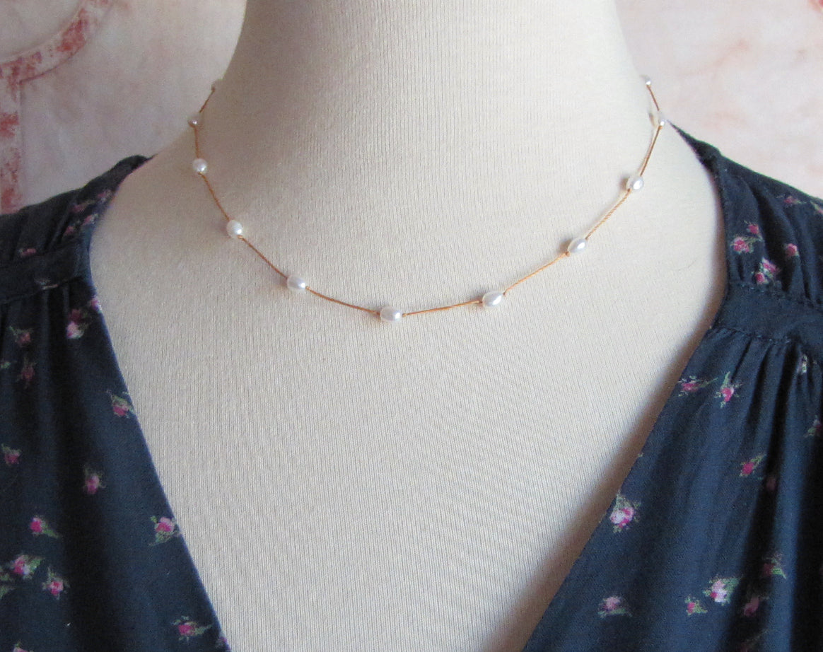 Freshwater pearl tin cup necklace on gold colored silk cord