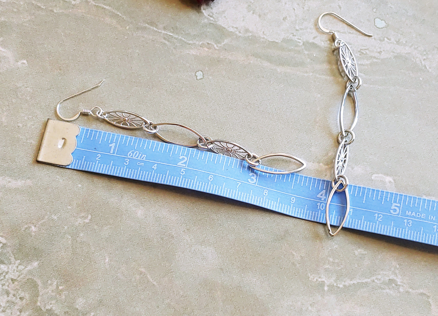 Leaf hoop and sunburst drop earrings in Rhodium and 24k gold plate